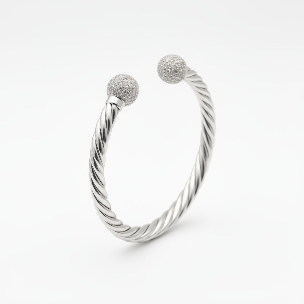 Silver bracelet with two textured ball charms on a white background